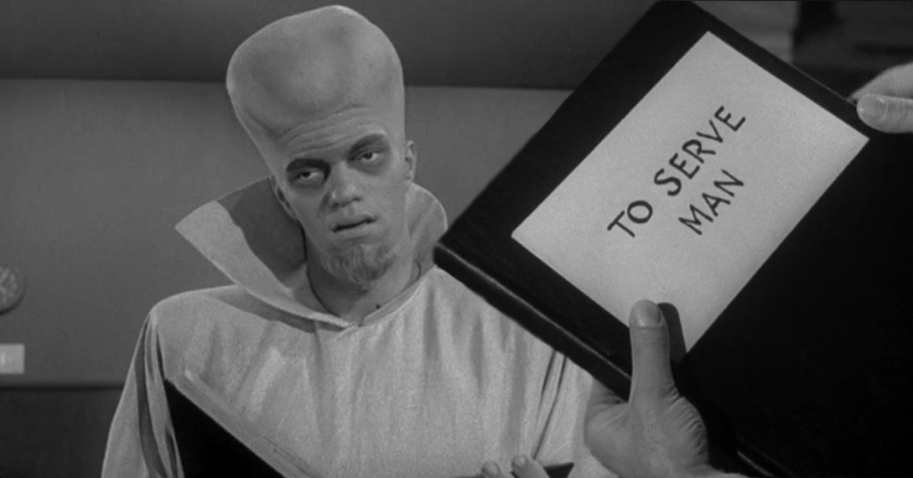 black and white image of extraterrestrial humanoid with large head in background. foreground is human hands holding alien book with a paper over it. on paper is written the translated title of book: to serve man